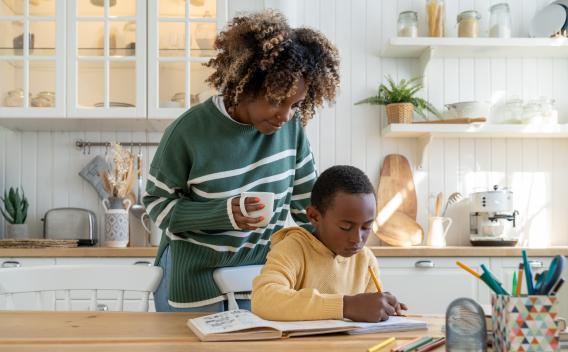 Mother watching Son do homework